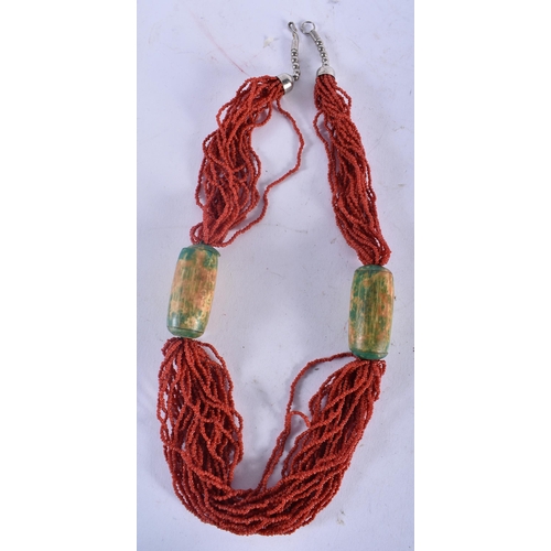 724 - A CORAL NECKLACE together with a malachite necklace & another. Largest 56 cm long. (3)