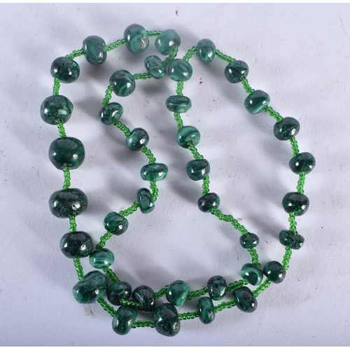 724 - A CORAL NECKLACE together with a malachite necklace & another. Largest 56 cm long. (3)