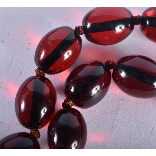 726 - A CHERRY AMBER TYPE RED BEAD NECKLACE. 85 grams. 82 cm long.