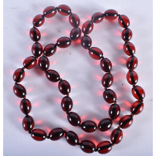 726 - A CHERRY AMBER TYPE RED BEAD NECKLACE. 85 grams. 82 cm long.