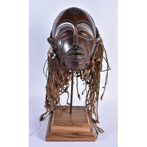 73 - A LARGE EARLY 20TH CENTURY AFRICAN TRIBAL WOOD MASK with later stand. 48 cm x 15 cm.