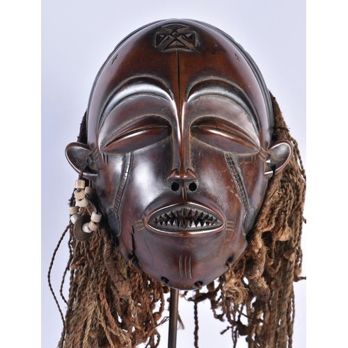 73 - A LARGE EARLY 20TH CENTURY AFRICAN TRIBAL WOOD MASK with later stand. 48 cm x 15 cm.