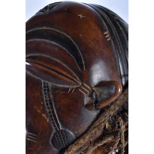 73 - A LARGE EARLY 20TH CENTURY AFRICAN TRIBAL WOOD MASK with later stand. 48 cm x 15 cm.