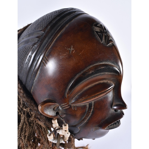 73 - A LARGE EARLY 20TH CENTURY AFRICAN TRIBAL WOOD MASK with later stand. 48 cm x 15 cm.