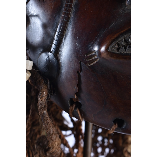 73 - A LARGE EARLY 20TH CENTURY AFRICAN TRIBAL WOOD MASK with later stand. 48 cm x 15 cm.