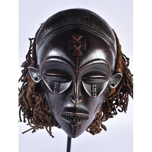 74 - A LARGE EARLY 20TH CENTURY AFRICAN TRIBAL WOOD MASK with later stand. 58 cm x 14 cm.