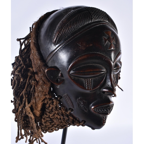 74 - A LARGE EARLY 20TH CENTURY AFRICAN TRIBAL WOOD MASK with later stand. 58 cm x 14 cm.