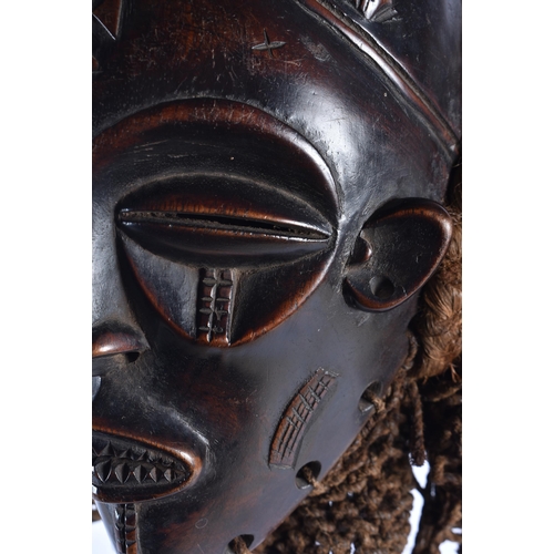 74 - A LARGE EARLY 20TH CENTURY AFRICAN TRIBAL WOOD MASK with later stand. 58 cm x 14 cm.