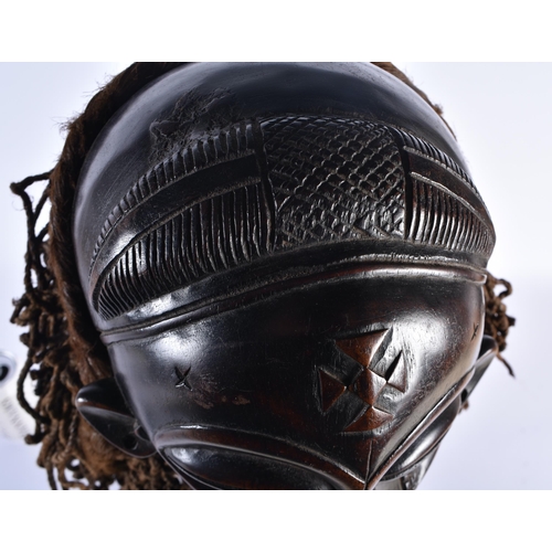 74 - A LARGE EARLY 20TH CENTURY AFRICAN TRIBAL WOOD MASK with later stand. 58 cm x 14 cm.