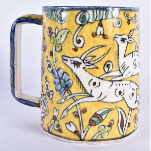 751 - A MIDDLE EASTERN FAIENCE IZNIK JERUSALEM POTTERY MUG painted with leaping deer. 12 cm x 10 cm.