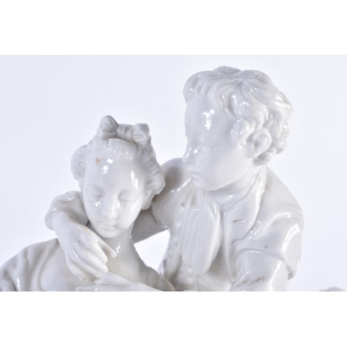 773 - A LARGE ANTIQUE NAPLES BLANC DE CHINE PORCELAIN FIGURAL GROUP modelled as two lovers beside a pair o... 