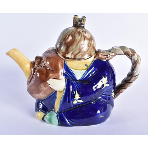 824 - AN ANTIQUE MAJOLICA TEAPOT AND COVER formed as a Chinaman. 19 cm wide.