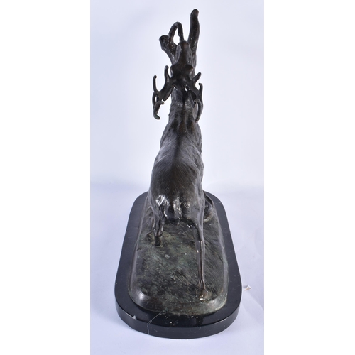 831 - A LARGE BRONZE AND MARBLE FIGURE OF A STAG modelled beside a tree stump. 44 cm x 36 cm.