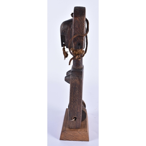 832 - A TRIBAL CARVED WOOD AFRICAN PULLEY. 24 cm high.