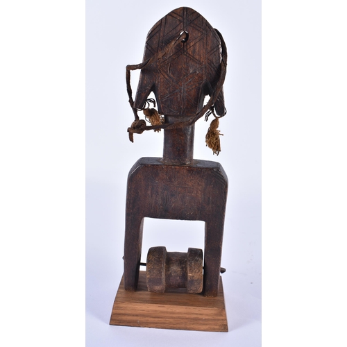 832 - A TRIBAL CARVED WOOD AFRICAN PULLEY. 24 cm high.