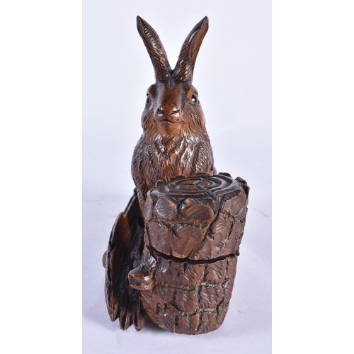 838 - A 19TH CENTURY BAVARIAN BLACK FOREST CARVED WOOD INKWELL formed as a seated rabbit beside a well. 18... 