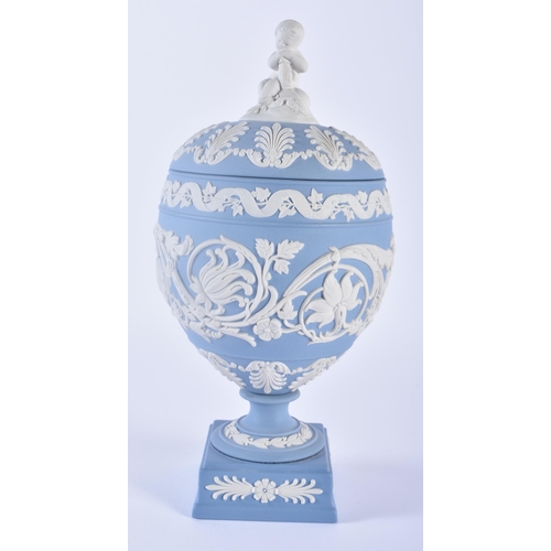 84 - A LOVELY WEDGWOOD BLUE JASPER WARE VASE AND COVER formed with a putti finial, upon a body decorated ... 