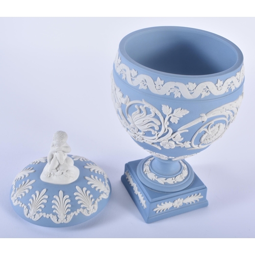 84 - A LOVELY WEDGWOOD BLUE JASPER WARE VASE AND COVER formed with a putti finial, upon a body decorated ... 