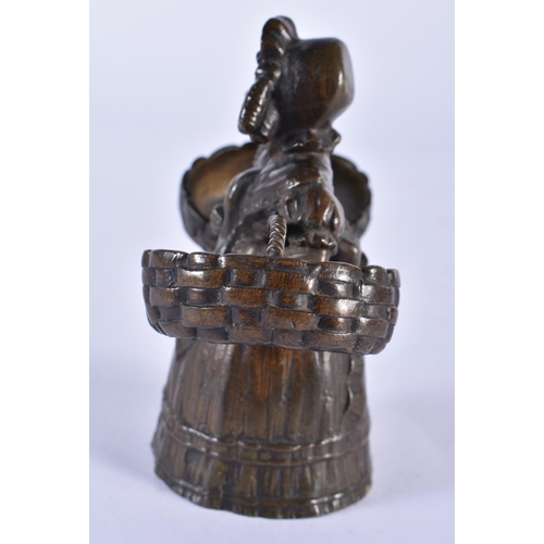 846 - AN ANTIQUE FRENCH BRONZE CANDLE SNUFFER formed as a female with baskets. 10 cm x 8 cm.