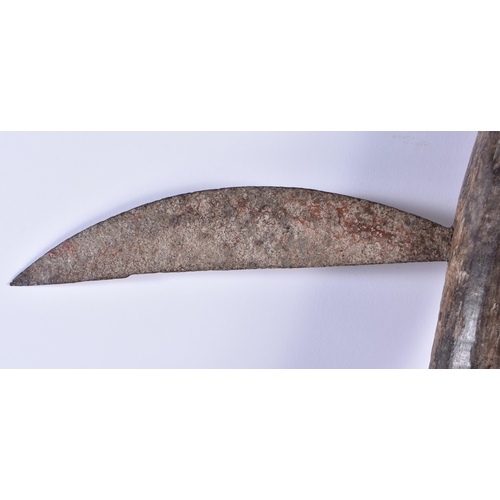 876 - A TRIBAL CARVED WOOD AXE. 55 cm long.