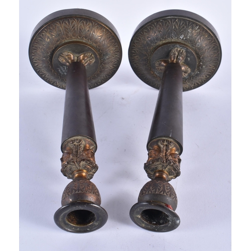 902 - A PAIR OF EARLY 19TH CENTURY FRENCH BRONZE TRIPLE MASK CANDLESTICKS formed upon acanthus bases. 27 c... 