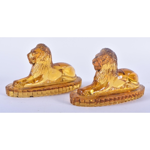 91 - A PAIR OF ANTIQUE MUSTARD YELLOW PRESSED GLASS LIONS. 12 cm x 8 cm.