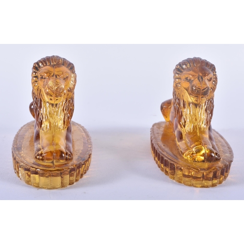 91 - A PAIR OF ANTIQUE MUSTARD YELLOW PRESSED GLASS LIONS. 12 cm x 8 cm.