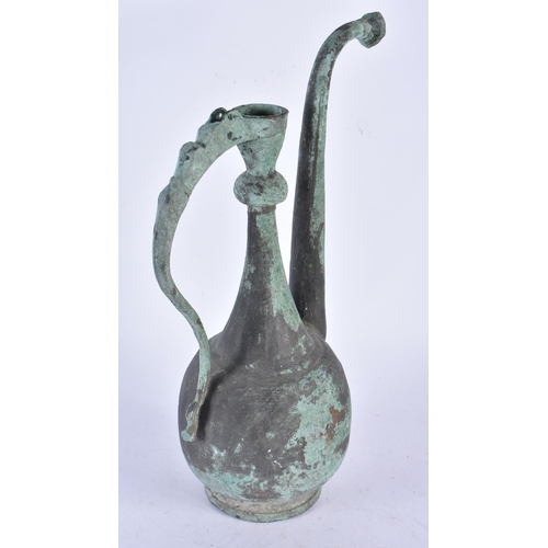 933 - An Early Middle Eastern Copper Ewer.  35cm x 17cm