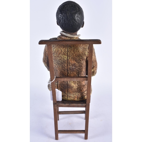 935 - A Blackamoor Figure of a Boy seated on a Chair.  Boy 40cm x 15cm x 14cn.  Chair 34cm x 14cm x 13cm (... 