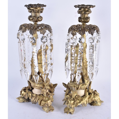 958 - A Pair of 19th Century Gilt Bronze Candlestick with Lustres decorated with Cherubs standing on Lily ... 