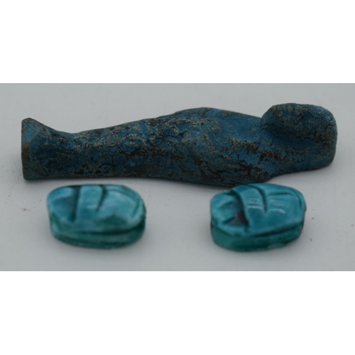 1034 - AN EGYPTIAN FAIENCE PHAROAH together with two scarab beetles. Largest 5.5 cm high. (3)