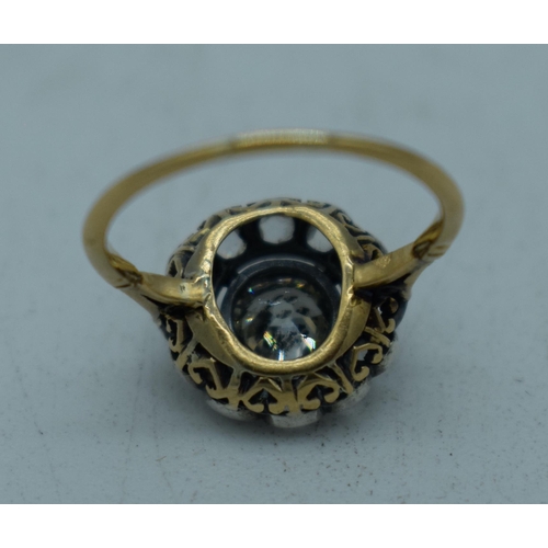 1102 - A LARGE ANTIQUE GOLD AND DIAMOND COCKTAIL CLUSTER RING. L. 2.3 grams. Central stone 0.5 cm x 0.5 cm.