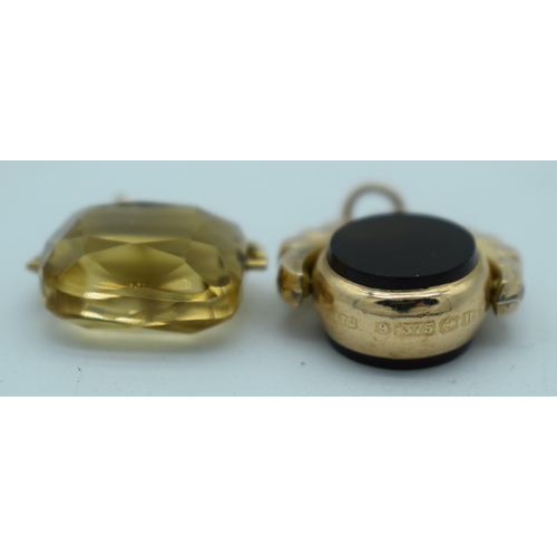 1137 - TWO 9CT GOLD WATCH FOBS. 8.9 grams. Largest 2.5 cm x 2 cm. (2)