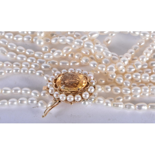 1269 - A Six Strand Pearl Necklace with a 14 Carat Gold and Citrine Clasp.  43cm long, weight 58.21g