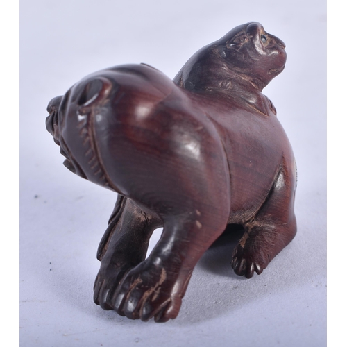 1272 - A Japanese Hardwood Netsuke carved as a dog with a Pup on its back.  4cm x 4cm