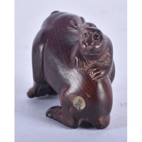 1272 - A Japanese Hardwood Netsuke carved as a dog with a Pup on its back.  4cm x 4cm