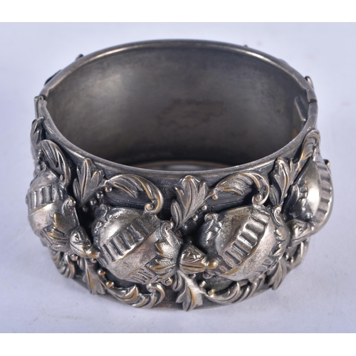 1302 - A Heavily Decorated Cuff Bangle in the Arts and Crafts Style.  Internal Diameter 5.7cm, weight 84g