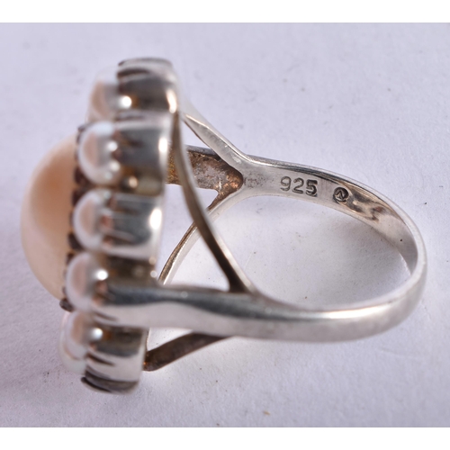 1310 - A Silver and Pearl Ring.  The central Pearl is surrounded by 12 smaller pearls.  Size Q, Stamped 925... 