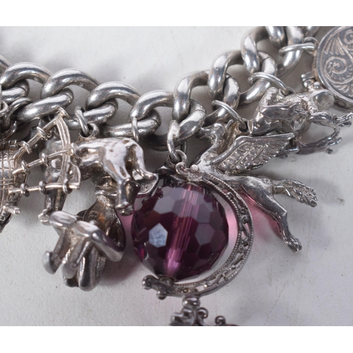 1371 - A Vintage Silver Charm Bracelet with 23 Charms.  Bracelet Hallmarked Birmingham 1966.  4.2 cm intern... 