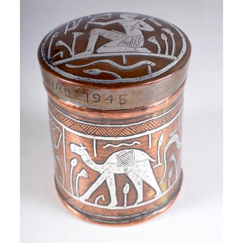 1420 - An Egyptian Copper Box and Cover with Silver Inlay figures.  Engraved Cairo 1945.  10cm x 7.8 cm, we... 