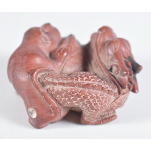 1474 - A Carved Hardwood Dragon Netsuke.  3.1cm x 6 cm x 5.2 cm, weight 38.6g