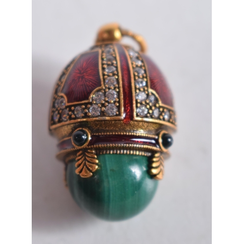 1476 - A Continental Silver Gilt, Enamel and Malachite Egg Pendant.  Stamped 84, 2.6 cm x 1.7cm, weight 10.... 