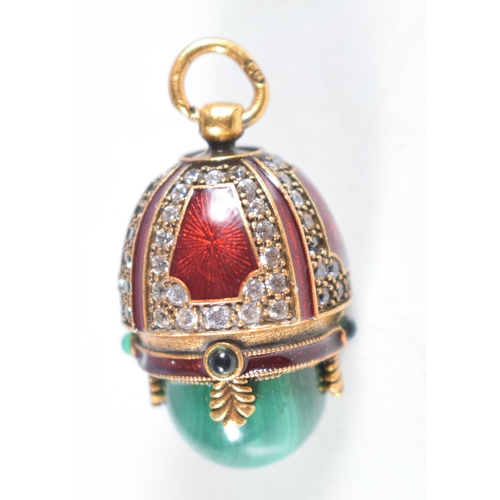 1476 - A Continental Silver Gilt, Enamel and Malachite Egg Pendant.  Stamped 84, 2.6 cm x 1.7cm, weight 10.... 