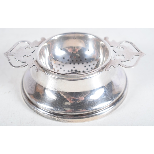 1481 - A Vintage Silver Tea Strainer on Stand by Lanson Ltd.  Hallmarked Birmingham 1959.  3 cm x 10.5 cm x... 