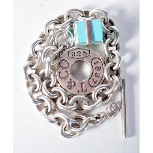 1573 - A Tiffany Silver Charm Bracelet with a Gift Box Charm.  Stamped Tiffany 925, 21cm long, weight 38.7g