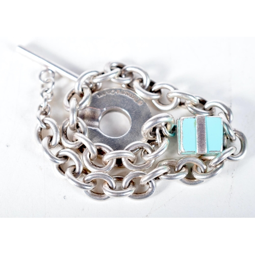 1573 - A Tiffany Silver Charm Bracelet with a Gift Box Charm.  Stamped Tiffany 925, 21cm long, weight 38.7g