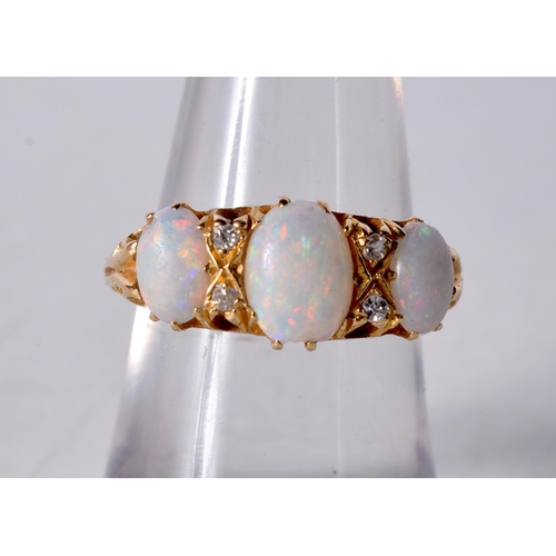 1610 - An 18 Carat Gold and Three Stone Opal Ring set with Diamonds... Stamped 18CT, Size N, weight 4.3g