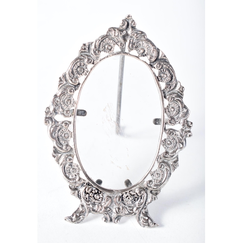 1613 - An Ornate Oval Continental Silver Desk Photo Frame.  Stamped 800.  9.5 cm x 6.7cm, weight 44.7g (inc... 