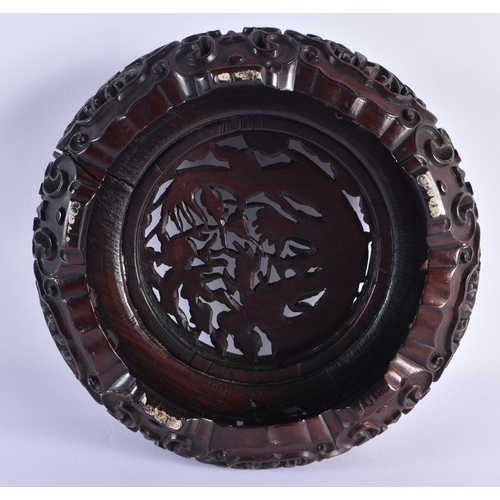 112 - A FINE EARLY 19TH CENTURY CHINESE CARVED HARDWOOD DRAGON STAND Qing, beautifully carved with a friez... 