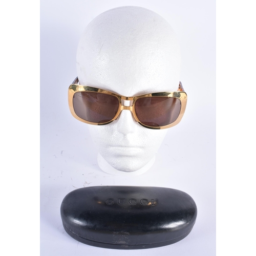 62 - A CASED PAIR OF GUCCI SUNGLASSES. 15 cm wide.